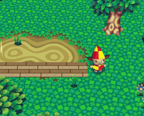 A player walking along a boardwalk, across a brick plaza and down a cobbled path, all made from the player's own designs laid on the ground
